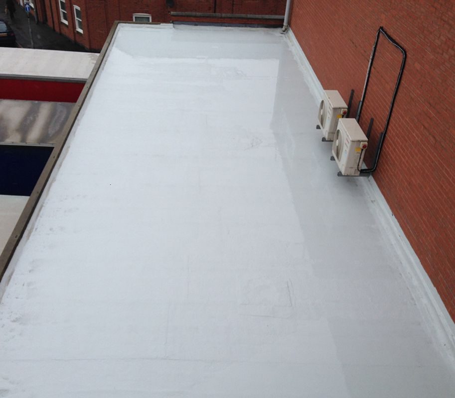 Liquid applied membrane completed on a flat roof with upstands and plant