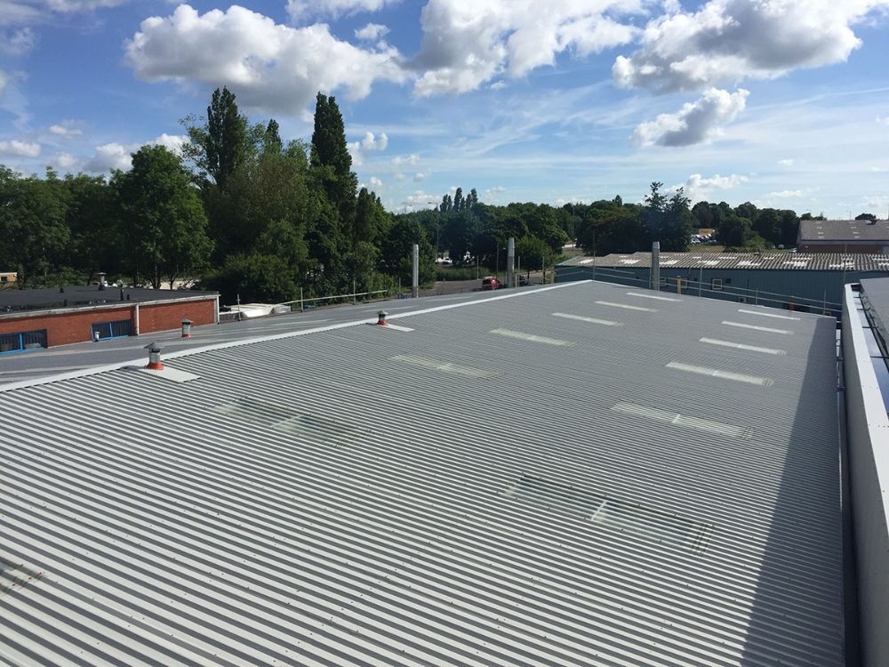 Profiled metal overcladding on an industrial roof