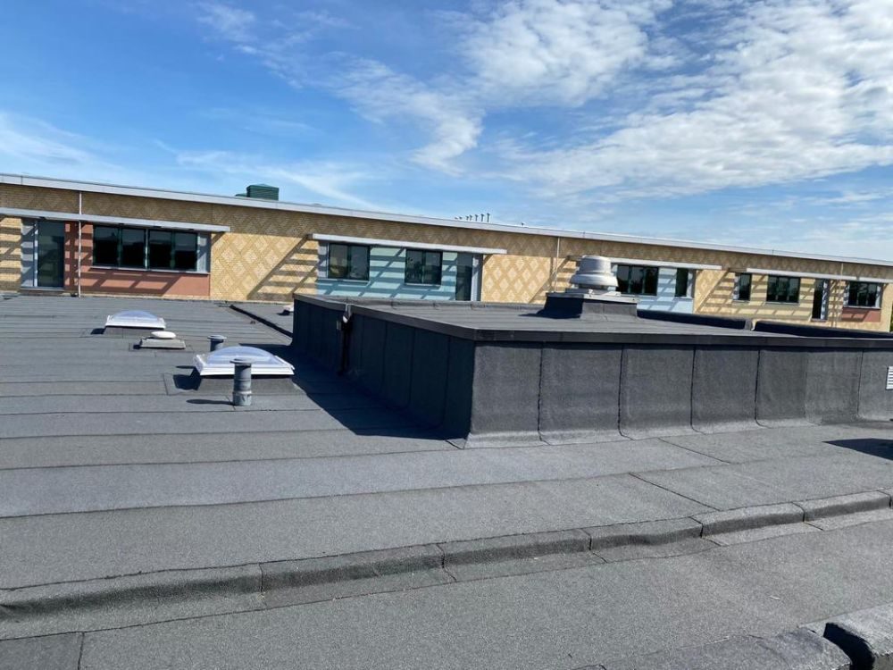 Completed bituminous roof with new rooflights and gutter details, Thomas Wolsey School, Ipswich